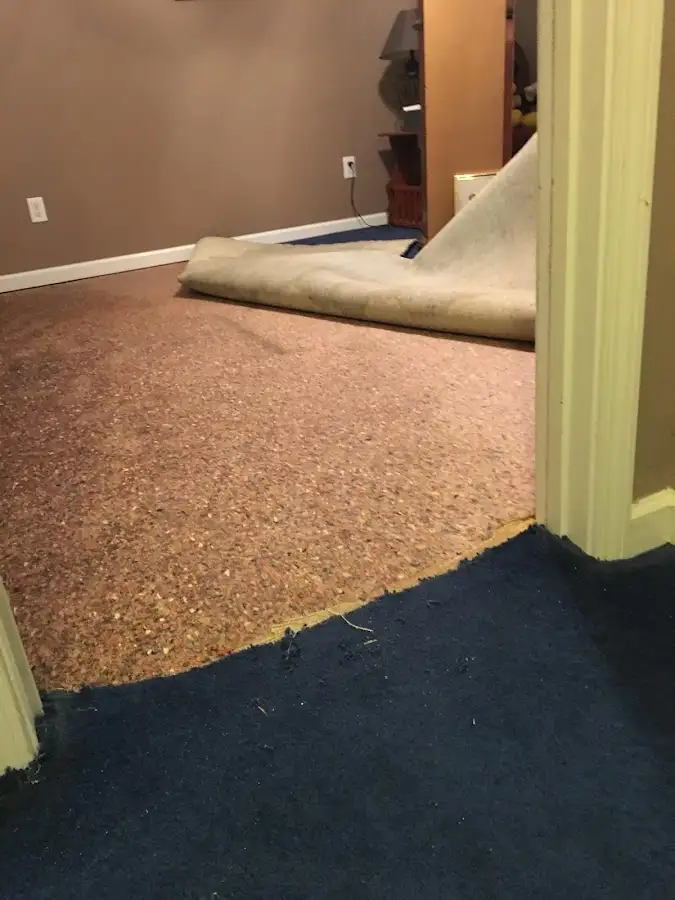 Carpet pad removal revealing water damage during Water Mitigation Services in Fort Stewart